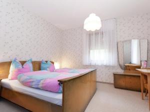 a bedroom with a bed and a mirror at Comfortable apartment in Baiersbronn with balcony in Buhlbach