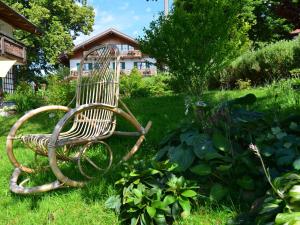 a bench sitting in the grass in a garden at Ländliche Ferienwohnung, Bad Bayersoien in Bad Bayersoien +32 photos