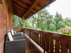 a porch of a cabin with benches and flowers at Apartment in Ruhpolding with Alps view in Ruhpolding