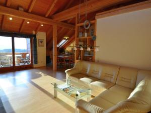 a living room with a couch and a table at Holiday home with panoramic view and every convenience spa in Waldkirchen