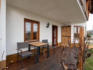a patio with a table and chairs on a house at Apartment on the edge of the forest in Kleines Wiesental