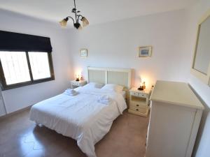 A bed or beds in a room at Villa with private pool in Benitachell