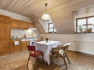 a kitchen with a table and chairs in a room at Secluded Apartment in Sch nsee Nearby the Forest in Schönsee