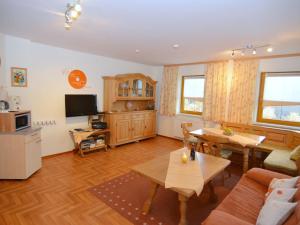 a living room with a couch and a table at Holiday flat with swimming pool in Prackenbach in Viechtach