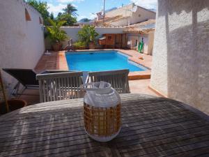 a table with a vase on a table with a pool at Belvilla by OYO Villa Jazmin in Albir