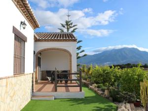 a patio with a table and a view of a mountain at Belvilla by OYO Casas Rurales Huetor in Viñuela