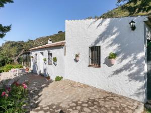 a white building with potted plants on it at Belvilla by OYO Casa Cantareros in La Joya