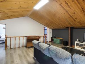 a living room with a couch and a wooden ceiling at Belvilla by OYO La Casa de Valen in Villamuriel de Cerrato