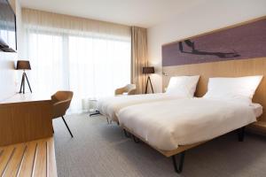 Postel nebo postele na pokoji v ubytování Hotel S-PORT Véska