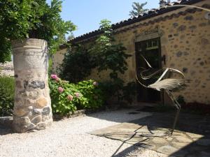a chair sitting in front of a building at Pretty Holiday Home in Ard che with Swimming Pool in Lalevade-dʼArdèche