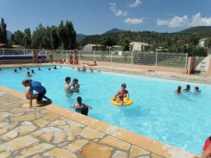 a group of people playing in a swimming pool at Holiday house nearby the Lac de Castillon in Castellane