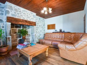 a living room with a couch and a fireplace at Comfortable holiday home with garden in Cassaniouze