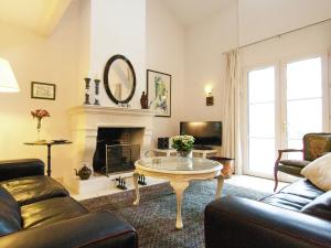 a living room with a couch and a table at Countryside villa in Polaca with private pool in Rouzède