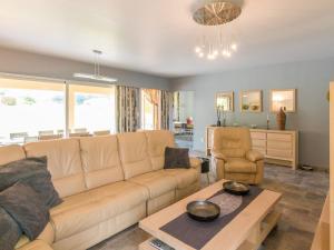 a living room with a couch and a table at Two comfortable houses with swimming pool near Monbazillac and Bergerac in Saint-Nexans