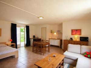 a living room with a couch and a table at Charming Cottage with Pool in V zac South of France in Beynac-et-Cazenac