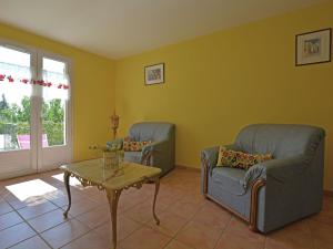 a living room with two chairs and a table at Spacious holiday home with private pool in Saint-Maximin