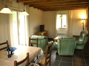 ein Wohnzimmer mit einem Tisch und Stühlen in der Unterkunft Modern holiday home with private pool in Loubressac