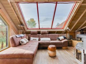 a living room with a couch and a large window at Loft with jacuzzi and sauna in Niderviller