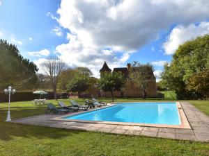 a swimming pool in the yard of a house at Vintage Holiday Home in Besse with Swimming Pool in Saint-Pompont