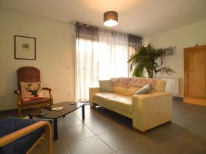 een woonkamer met een bank en een stoel bij Holiday home with private garden in Wierre Effroy in Rinxent
