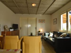 uma sala de estar com cadeiras amarelas e um sofá em Modern holiday home with lovely garden em Saint-Honoré-les-Bains