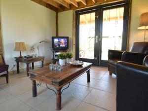 a living room with a coffee table and a tv at Modern holiday home with lovely garden in Saint-Honoré-les-Bains