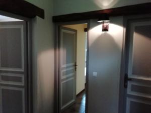 a hallway with two doors and a light on the wall at Modern holiday home in Quend Plage les Pins in Quend