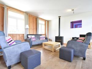 a living room with couches and a fire place at Spacious Holiday Home with Swimming Pool in Cuzy in Cuzy