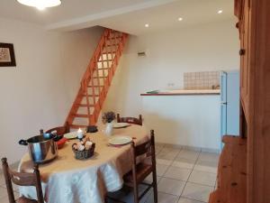 a dining room with a table and a staircase at Holiday home with swimming pool in Quend