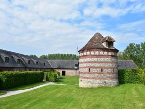 a brick chimney in the yard of a house at Classic Cottage in Le Bourg Dun with Garden in Le Bourg-Dun