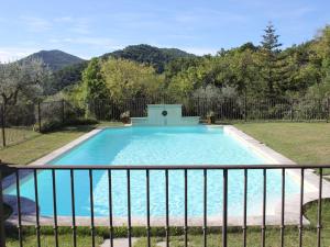 a swimming pool in a yard with a fence at Superb country house with private pool in Vaison-la-Romaine