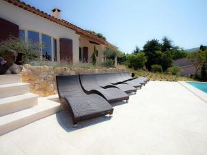 a row of benches sitting next to a pool at Luxury villa in Provence with a private pool in Martres-Tolosane