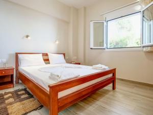 a bedroom with a large bed with a window at Seaview Studio 5 pers panoramic seaview in beautiful setting in Ravdhoúkha