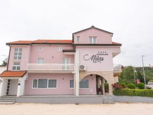 a pink building with a mulka sign on it at Pretty Apartment in Imotski close to River in Imotski