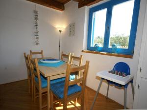 a dining room with a table and chairs and a window at Lovely Villa in Ka telir Croatia with Private Pool in Labinci
