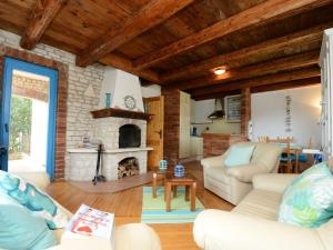a living room with couches and a fireplace at Lovely Villa in Ka telir Croatia with Private Pool in Labinci