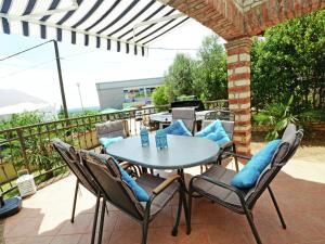 a patio with a table and chairs on a balcony at Lovely Villa in Ka telir Croatia with Private Pool in Labinci