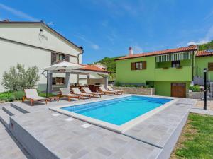 a villa with a swimming pool and a house at Apartment in Istria with Nature Views in Cerovlje