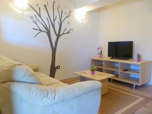 a living room with a tree stenciled on the wall at Cozy Holiday Home in Valtura with Swimming Pool in Valtura