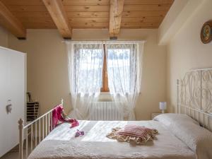 a bedroom with a white bed and a window at Belvilla by OYO Casa Volpara in Pergola