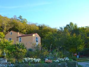 a house in the middle of a garden at Belvilla by OYO Cozy Holiday Home with Pool in Carbuta