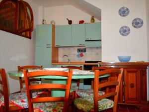 a kitchen with a table with chairs and a sink at Farmhouse in Vinci with Swimming Pool Terrace Garden BBQ in Vinci