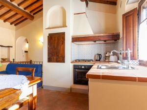 a kitchen with a sink and a stove at Belvilla by OYO Grano in Cortona