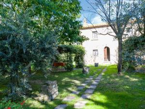 a garden with a stone path in front of a house at Belvilla by OYO Grano in Cortona