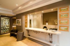 a salon with a counter and a mirror in a room at Hotel Prins Boudewijn in Knokke-Heist