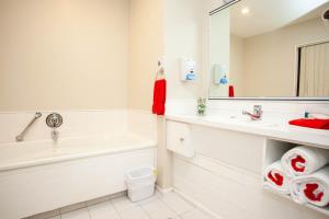 a bathroom with a sink, toilet and bathtub at Cascades Lakefront Motel in Taupo