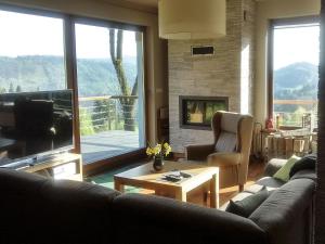 a living room with a couch and a television at Modern Villa in Zwardon with Sauna in Zwardoń