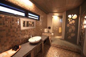 a bathroom with a sink and a tub and a toilet at Fanlin House in Jialin