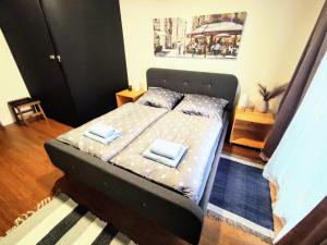 a bed with two pillows on it in a bedroom at Apartman Park Žilina & Free Parking in Žilina