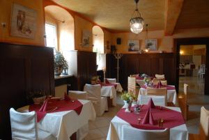 a dining room with white tables and red napkins at Hotel Schwarzer Bär in Zittau